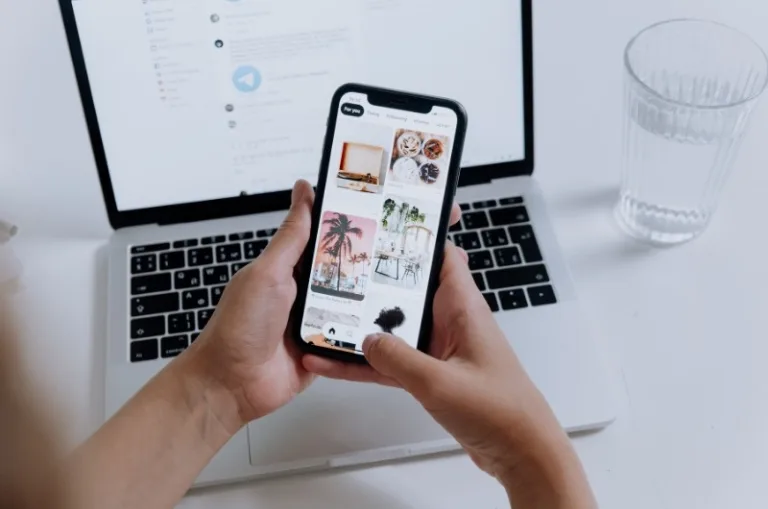 person browsing a small business website on a phone; designer building a website layout on a laptop for small business web design in Lynnwood